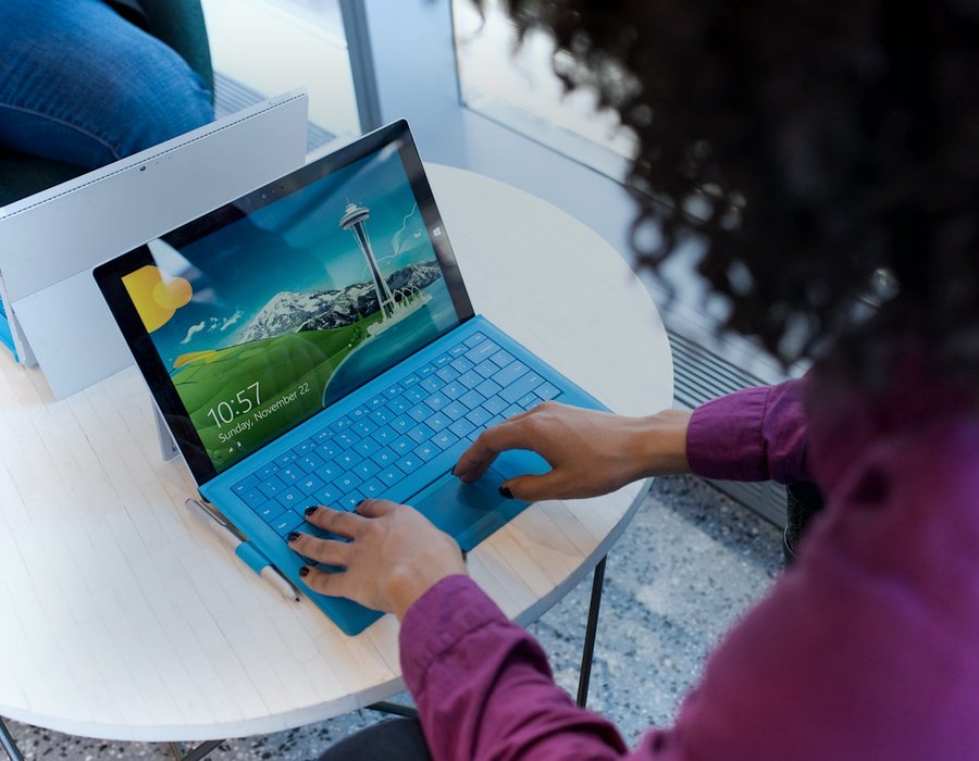 Person using a laptop at a round table